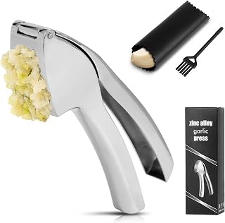 Stainless steel garlic press filled with freshly crushed garlic, with silicone peeler, cleaning brush and gift box
